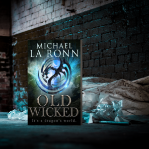 The background of the meme is blue, bricks and maybe trash with the Dragon cover to one side